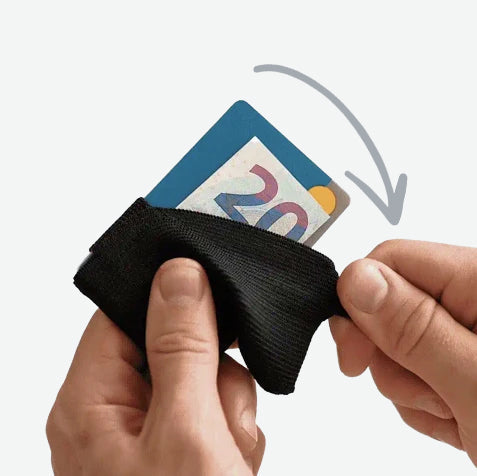 A hand folding the elastic tab aside as a card and a folded note lift out of the wallet