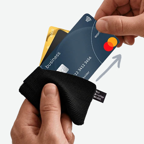 Cards fanned up out of a YAW wallet with one being drawn from the top